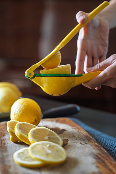 Fresh Lemon Juice Being Squeezed with Citrus Press