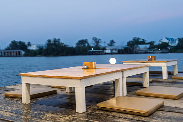 istock A wooden table with a white tablecloth and a few chairs with cushions 2218695722
