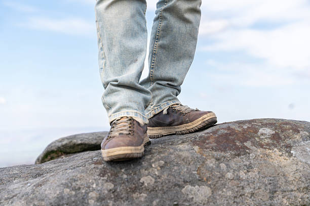 istock Discovering nature while standing on rocky outcrop in comfortable walking shoes during a bright and sunny day 2218696193