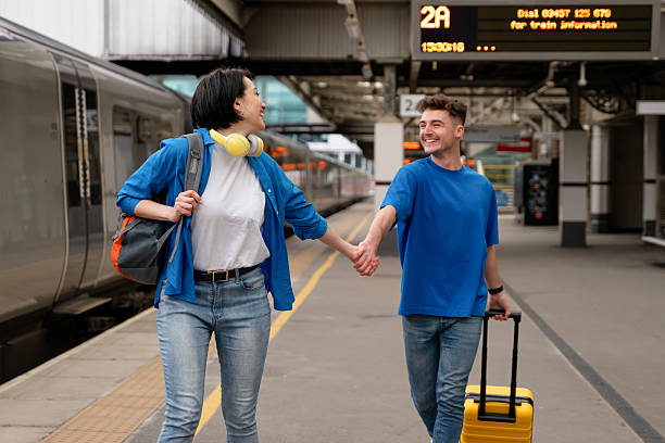 istock Couple enjoying time together at train station while preparing for travel in spacious terminal setting during morning hours 2218696840