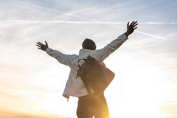 istock Person embraces freedom against sunset backdrop in nature 2218698145