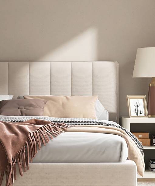 istock Modern cream colored bed with bedside table, lamp in minimal, cozy bedroom in sunlight from sliding door for luxury interior design decoration, product display background 3D 2218698305