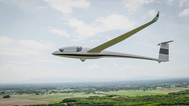 istock A sleek, white glider soars gracefully over a picturesque landscape 2218699307