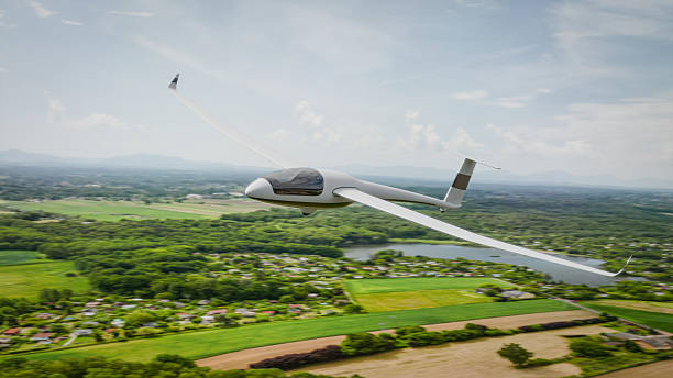 istock A sleek, white glider soars gracefully over a picturesque landscape 2218699312