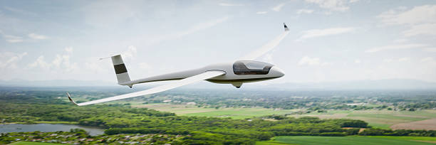 istock A sleek, white glider soars gracefully over a picturesque landscape 2218699316