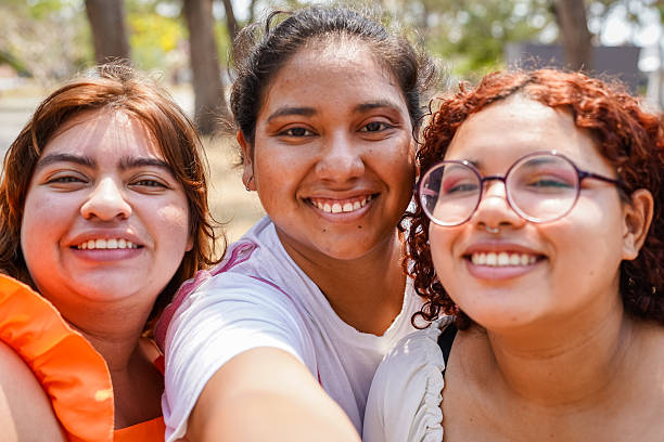 istock Three happy young women taking a selfie outdoors 2218699558