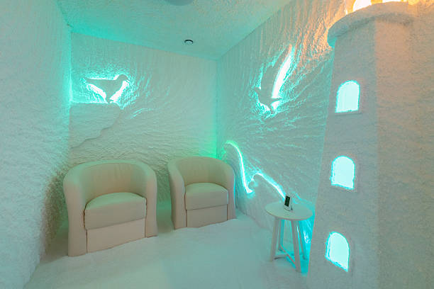 istock Modern Salt Room Interior With Turquoise LED Lighting And Comfortable White Lounge Chairs 2218706378