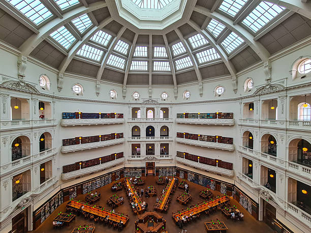 Melbourne, Australia – December 26, 2022: The grand dome of the La Trobe Reading Room inside the State Library Victoria, one of Melbourne’s most iconic public spaces. The octagonal reading room features white walls, timber desks, and a soaring glass ceiling.Free to enter, the library hosts exhibitions, guided tours, and a peaceful escape from the city’s bustle.