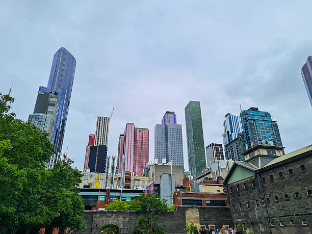 Melbourne, Australia – December 26, 2022: High-rise buildings of Melbourne’s central business district along the Yarra River, showcasing the city’s evolving skyline and vibrant waterfront development. Strolling along the Yarra promenade offers access to restaurants, bars, art installations, and a popular riverside cycling path.