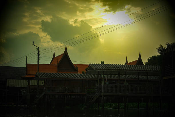 Golden sky over a canalside community in a vintage film photograph.