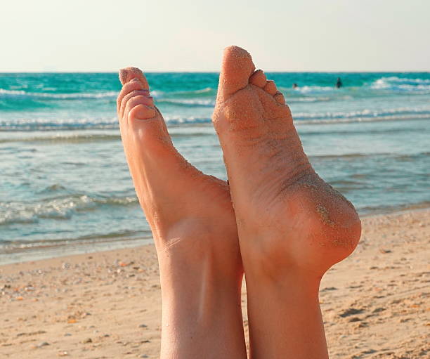 istock Feet Sandy Close-up Natural Light Relaxing Beach Summer Vacation 2218711207