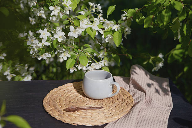 istock Morning coffee on a woven mat surrounded by blooming flowers 2218712107