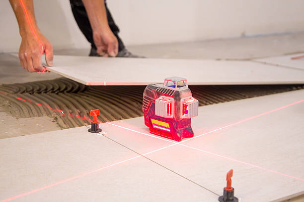 istock Tiler lays new floor tiles 2218713330