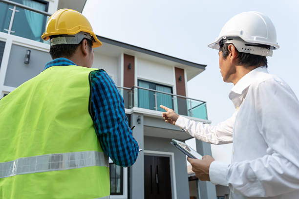 istock inspector engineer and owner project is inspecting construction and quality assurance new house. Engineers or architects or contactor work to build the house before handing it over to the homeowner 2218714089