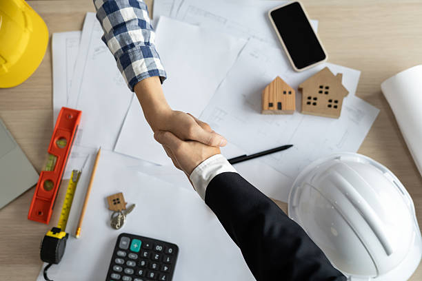 istock Construction team hands shaking greeting start up plan new project contract in office center at construction site, industry ,architecture, partner, teamwork, agreement, property, contacts. 2218714097