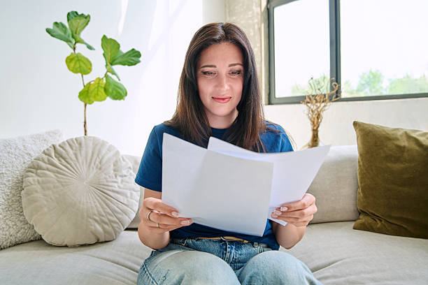 istock Webcam view young serious woman with business papers having video 2218715468