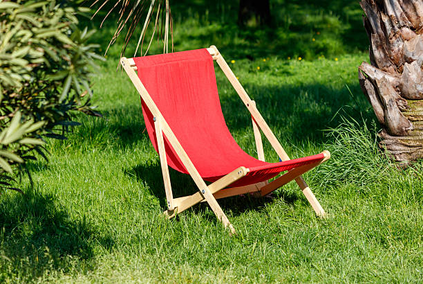 Red and white striped beach chair isolated on white background. Summer holiday and vacation concept. 3D render.