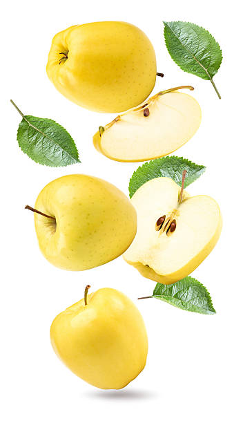 istock flying yellow apples with green leaf and slices isolated on a white background. clipping path 2218718651