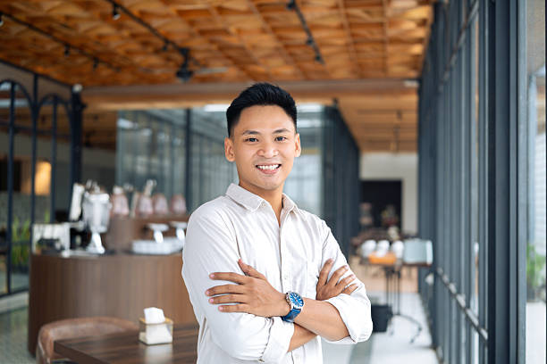 istock Smiling Professional Man Standing Confidently in a Modern Office Interior 2218720975