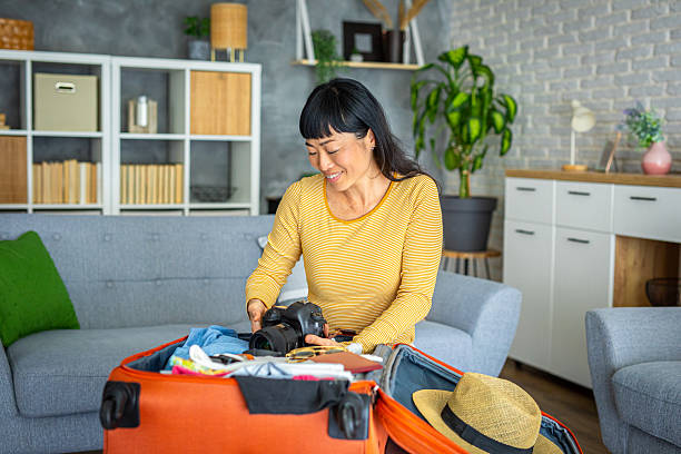 istock Happy Traveler Preparing for Trip with Camera Gear 2218722693