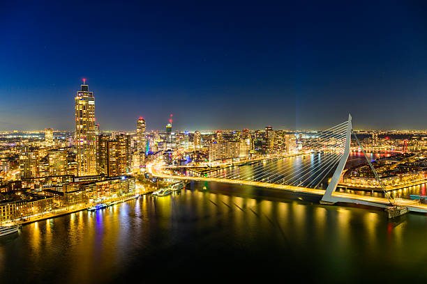 Rotterdam nighttime view of the skyline seen from a height at the Maas with the Erasmusbrug and the Zalmhaven. The bridge, often referred to as the \