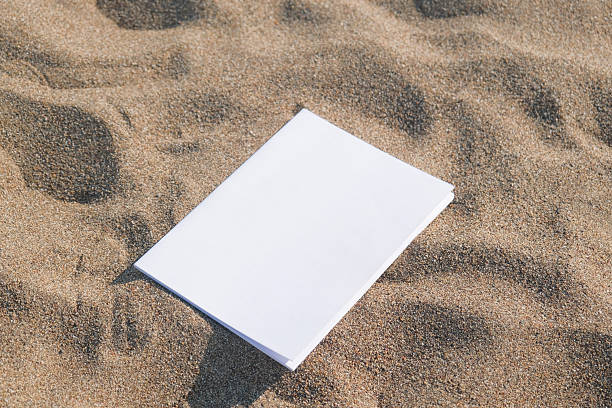 istock blank magazine mockup on sandy beach 2218725511