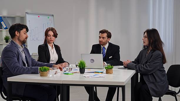 istock Business Meeting with Four People in Office Setting 2218725527