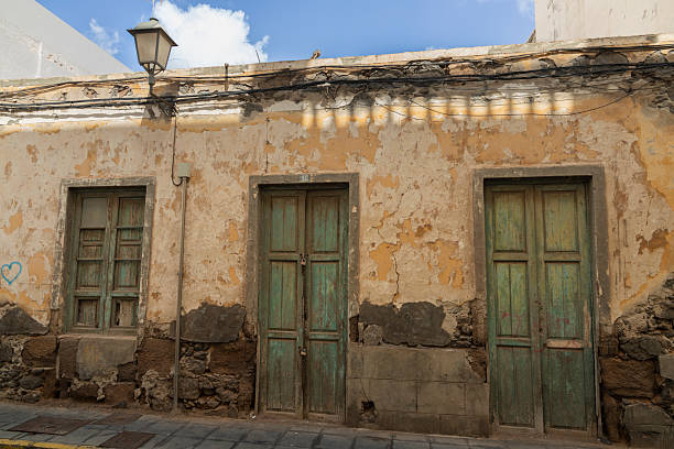 istock Old house with bleached green doors and windows in Spain 2218727330