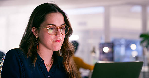 istock Young Woman Working in a Modern Office Environment on a Laptop 2218728080