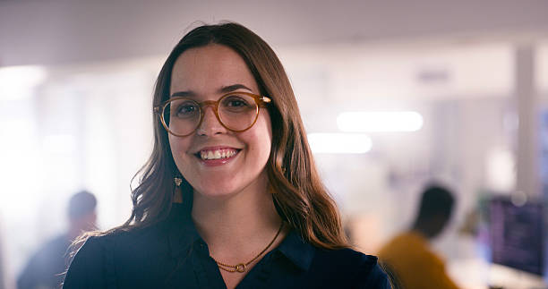 istock Confident Professional Woman Smiling in a Modern Office Environment with Gentle Lighting 2218728090