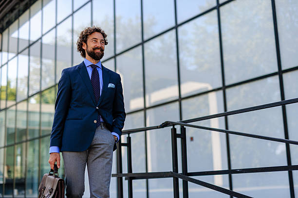 istock Elegant Man in Business Attire Passing Office Building 2218731990