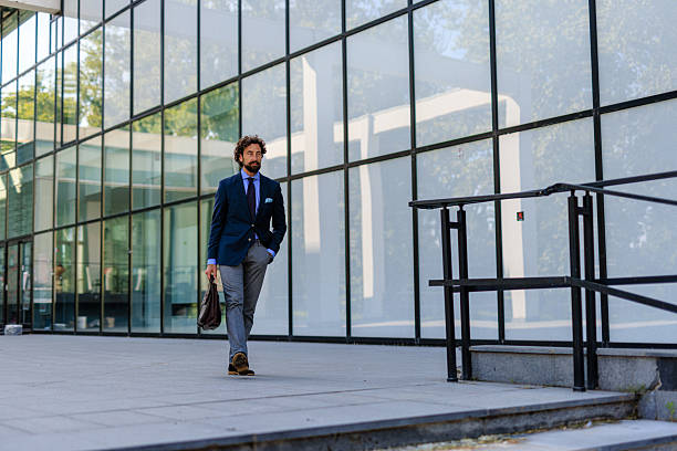 istock Confident Businessman Walking Outside Modern Office Building 2218731991