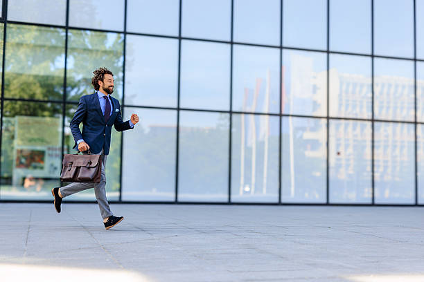 istock Businessman Running with Briefcase in Urban Setting 2218732355