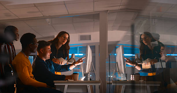 istock Collaborative Team Working Together at a Late-Night Office Session with Technology 2218732497