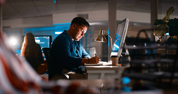 istock Focused Professional Working Late at Night in Modern Office Setting 2218732502