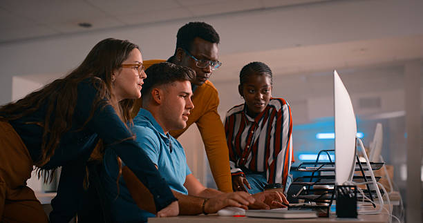 istock Diverse Team of Professionals Collaborating on a Project at a Computer in a Modern Office Environment 2218732545