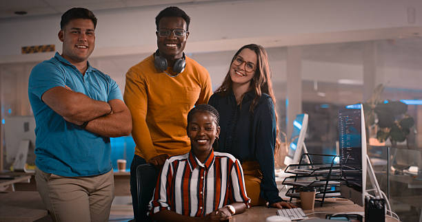 istock Team of Diverse Professionals Collaborating in a Modern Office Workspace at Night 2218732547