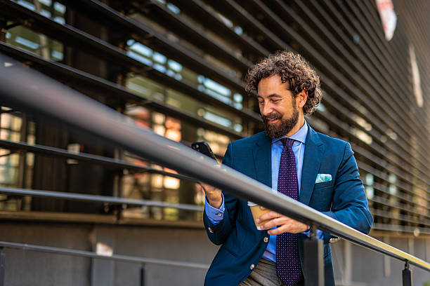 istock Urban Executive on the Go with Coffee and Smartphone 2218732854