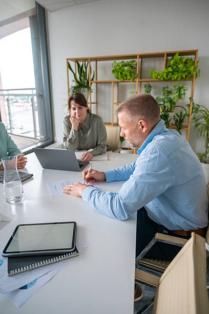 istock Focused Business Executives Collaborating in Bright Office with Modern Green Decor 2218732931