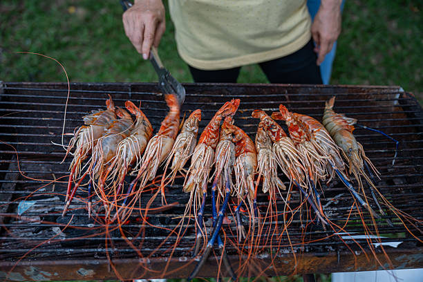 Cooking BBQ fresh prawns at camping. Grill fresh seafood for dinner.