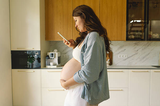 istock Expecting mother using smartphone in modern kitchen during pregnancy 2218736605