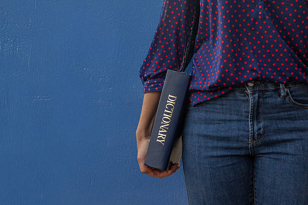 Person with Dictionary on Blue Background