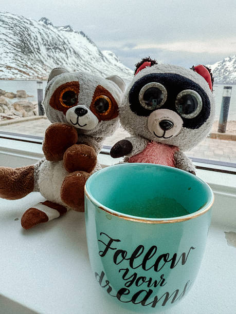 Plush Toys by Window with Inspirational Mug and Snowy Mountain View