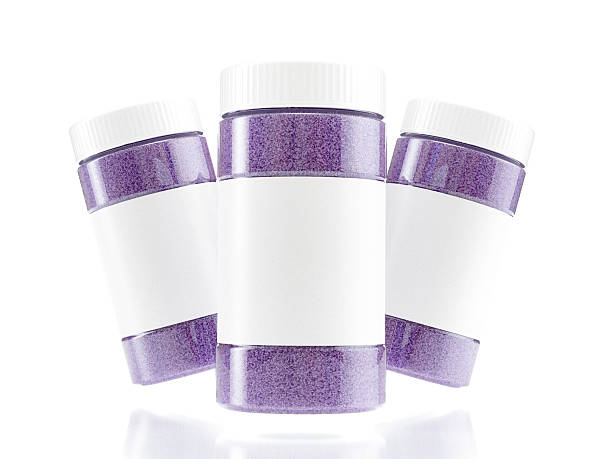 A clean, studio shot of three salt bath jars filled with vibrant magenta salt, presented to showcase the product packaging and color. The bright blue evokes a feeling of relaxation.