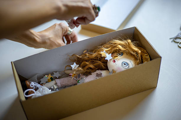 Creative entrepreneur carefully packages her unique handmade doll, ensuring it arrives safely to the buyer