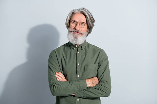 istock Portrait of attractive minded grey-haired man expert thinking copy blank space folded arms isolated over gray pastel color background 2218748410