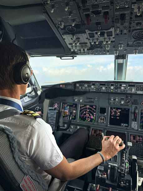 istock Commercial airline pilot operating cockpit in flight 2218749239