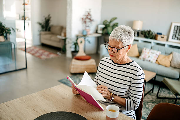 istock An elderly woman is reading a book. 2218751299