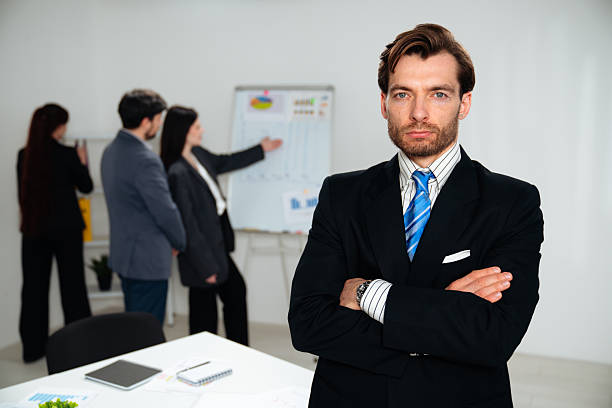 istock Confident Businessman Leading a Presentation in a Modern Office 2218751647