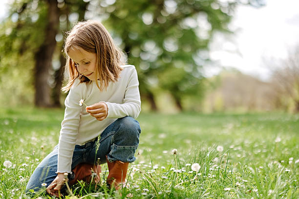 istock Girl is picking flowers 2218751878